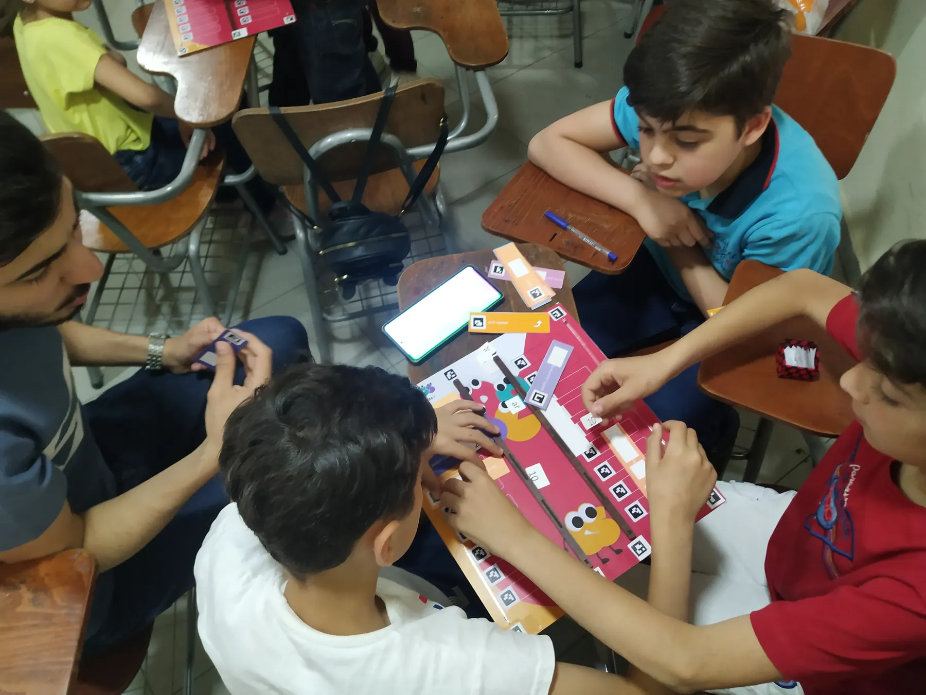 Children learning to code with the CoKids kit