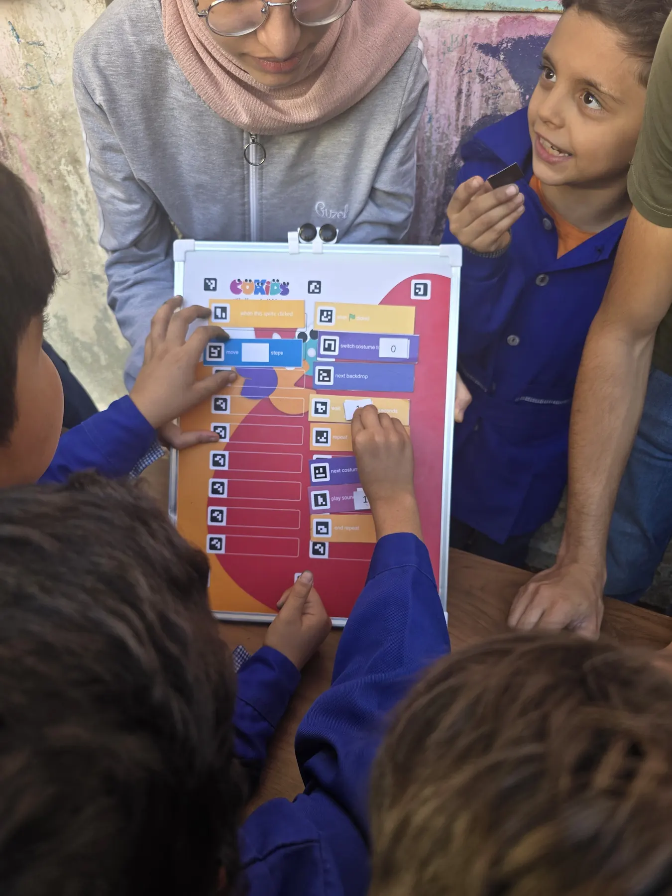 Children learning to code with the CoKids kit