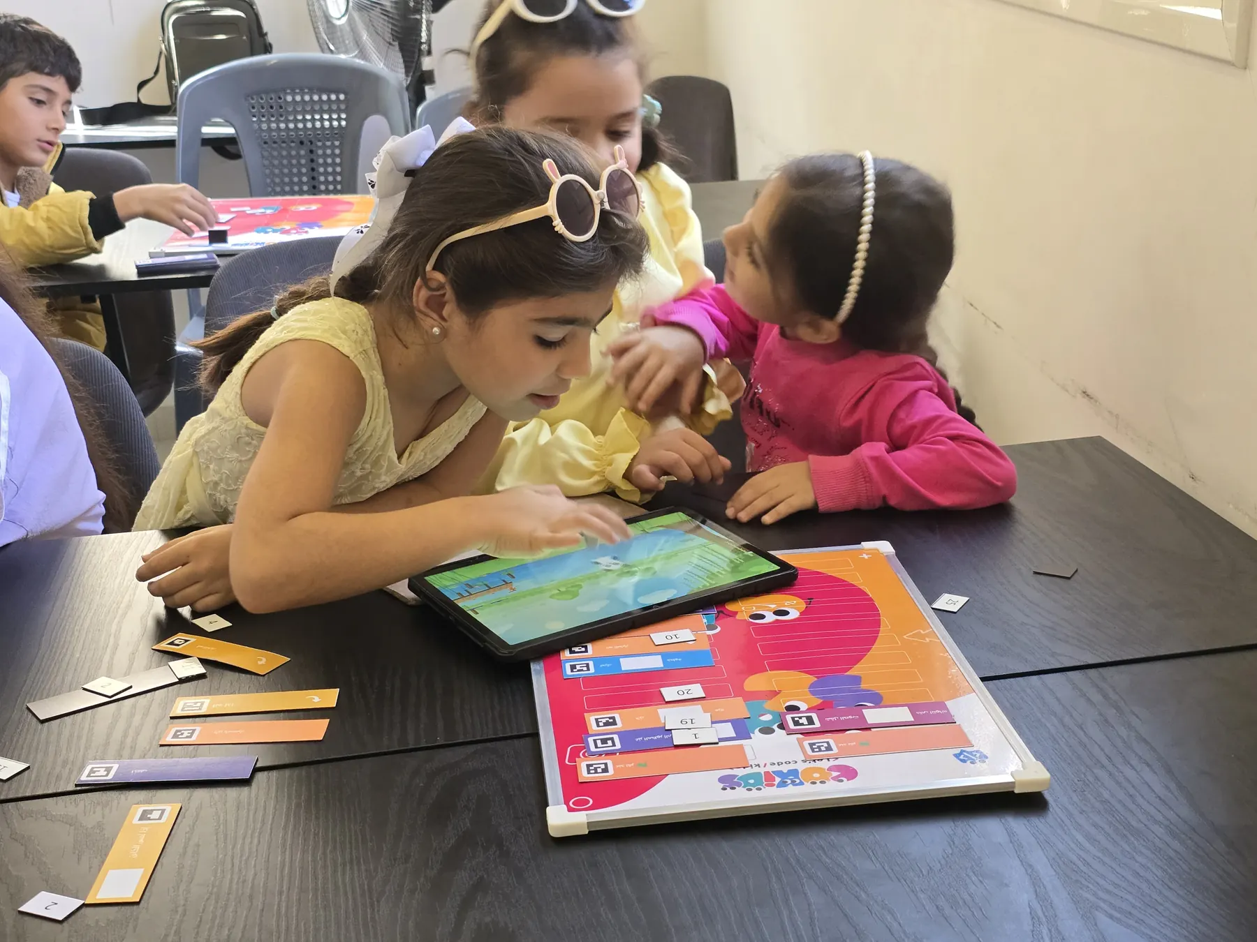 Children learning to code with the CoKids kit