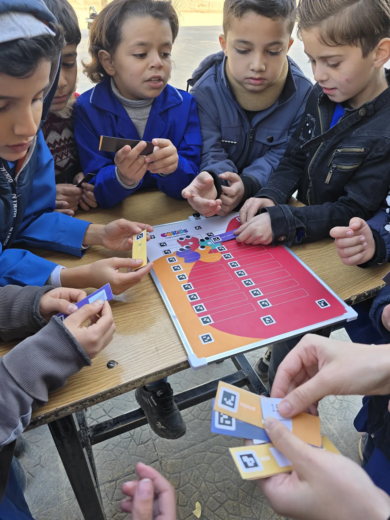 Children learning to code with the CoKids kit