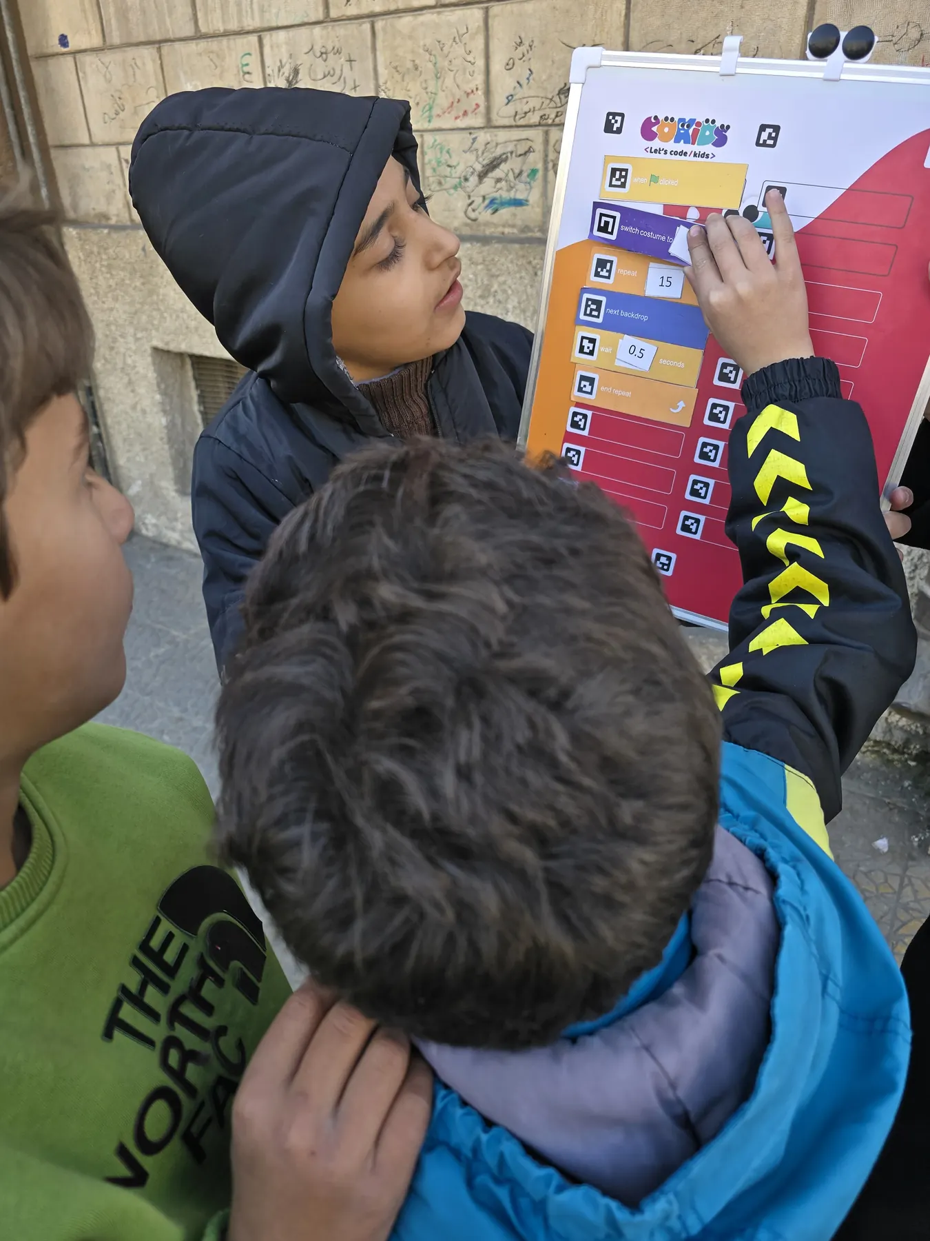 Children learning to code with the CoKids kit