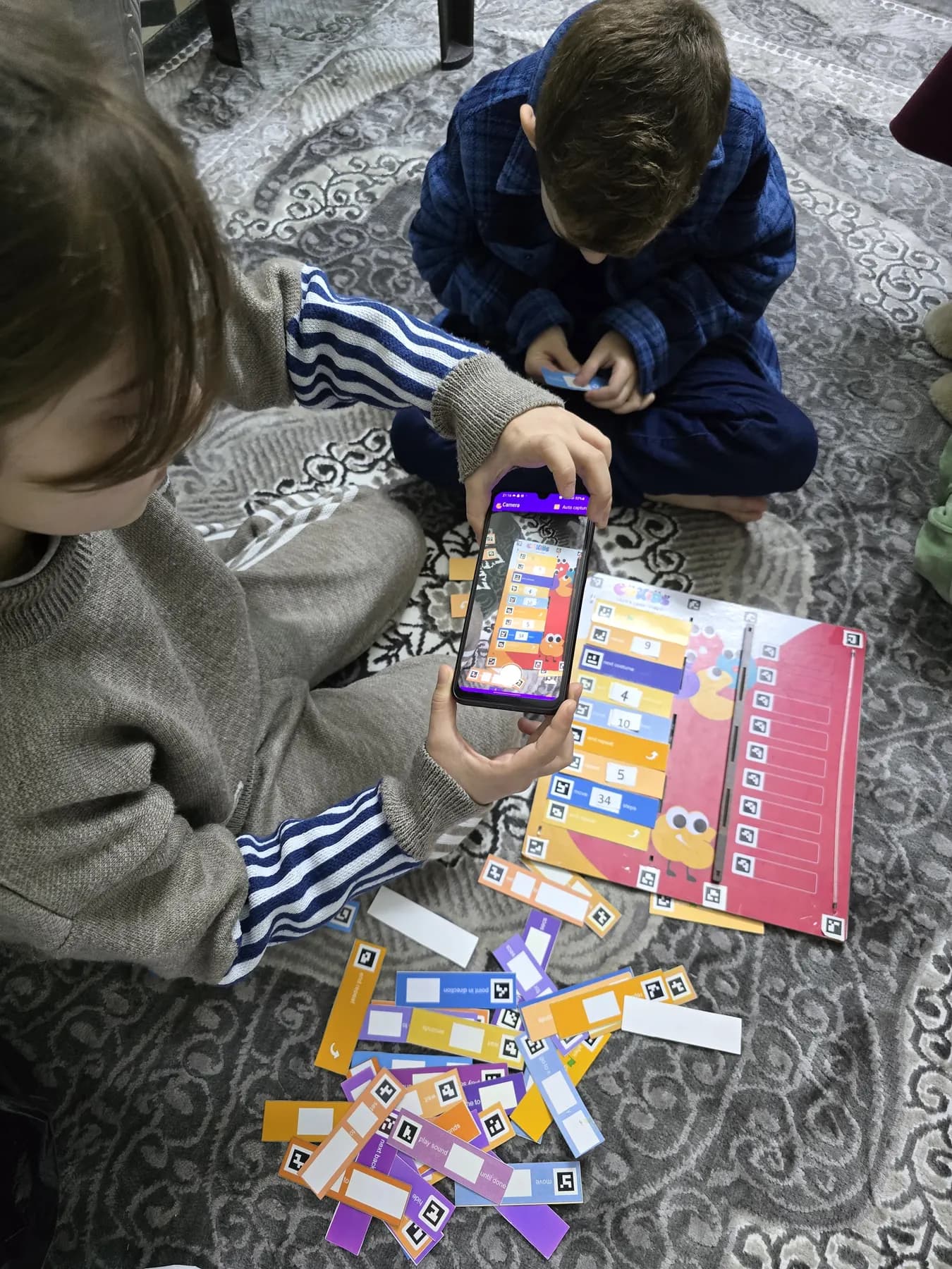 Children learning to code with the CoKids kit