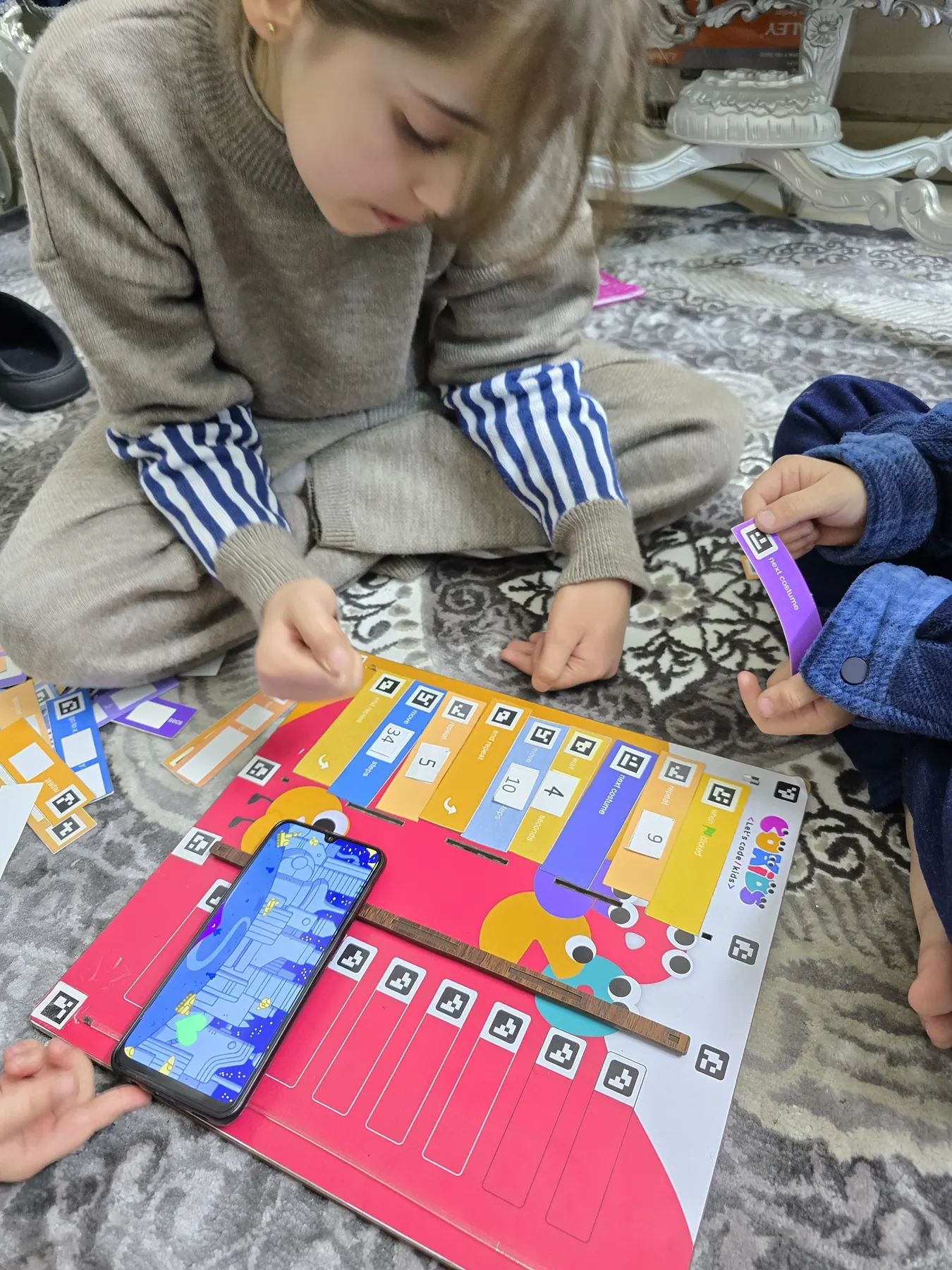 Children learning to code with the CoKids kit