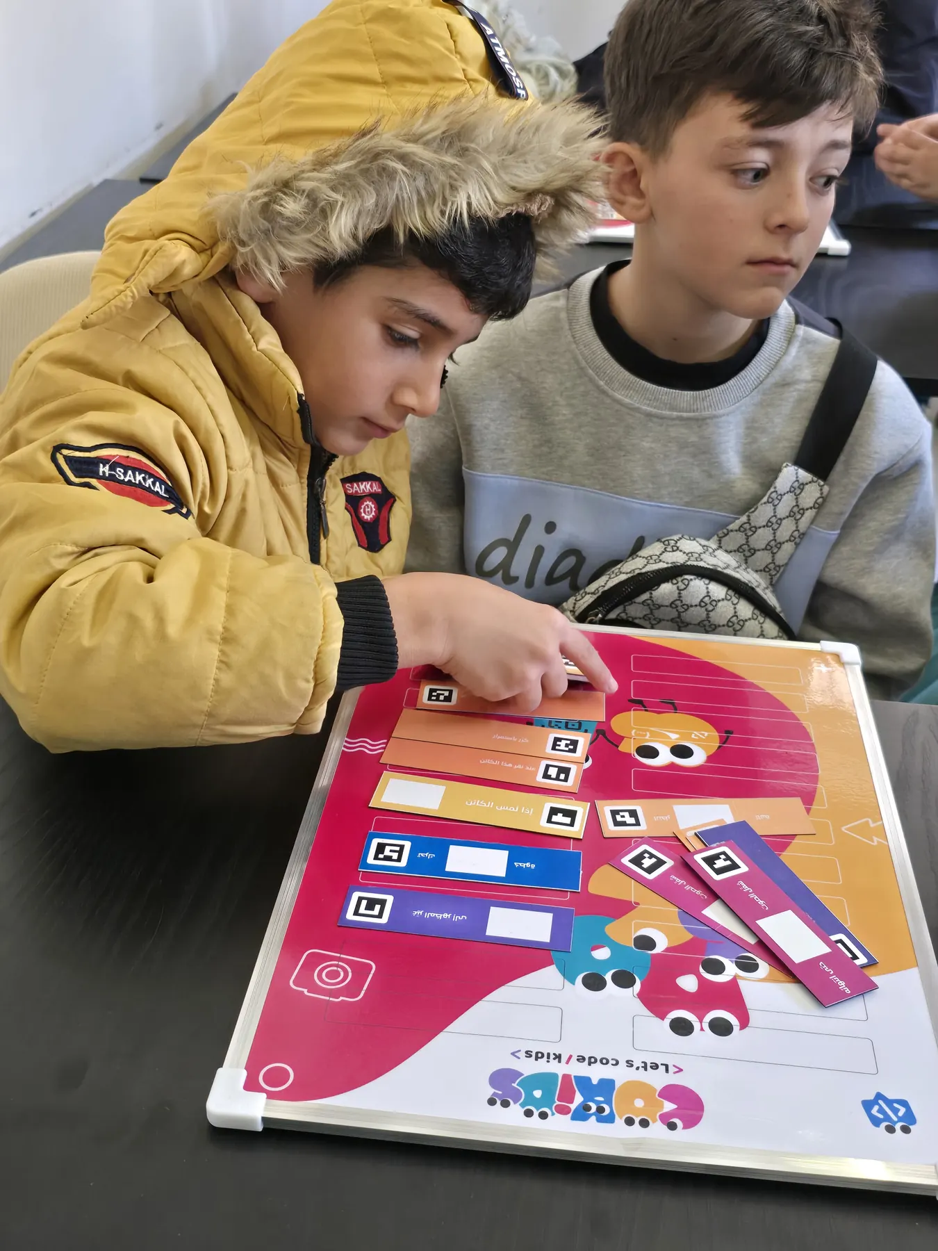 Children learning to code with the CoKids kit