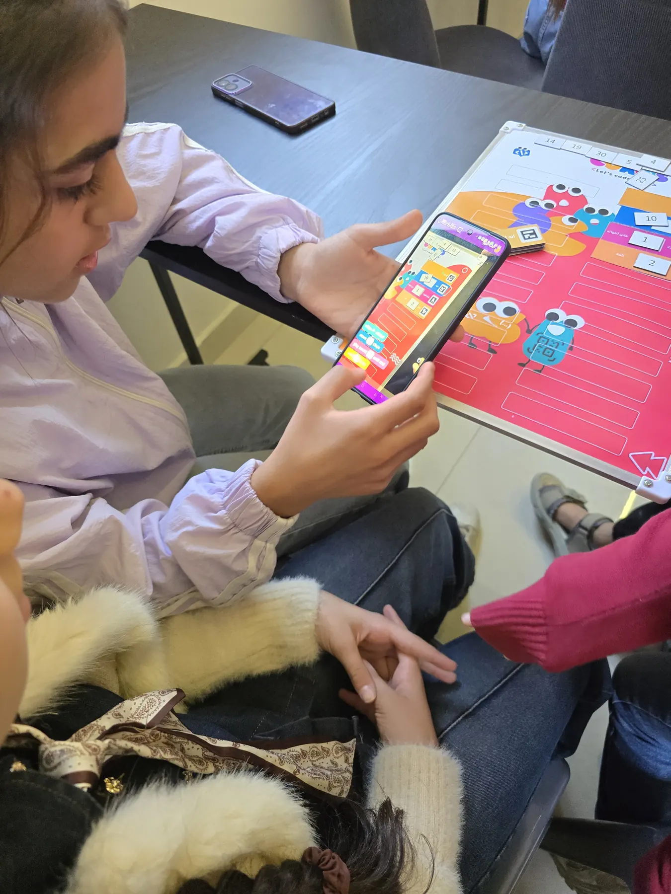 Children learning to code with the CoKids kit