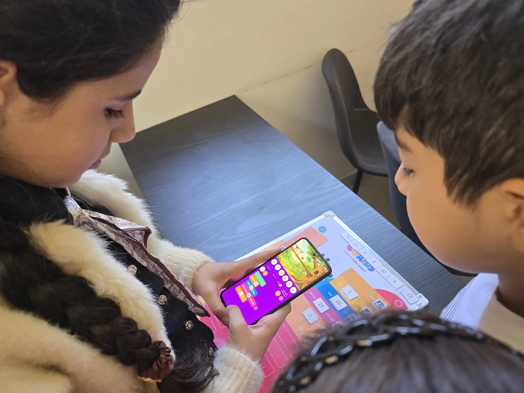 Children learning to code with the CoKids kit