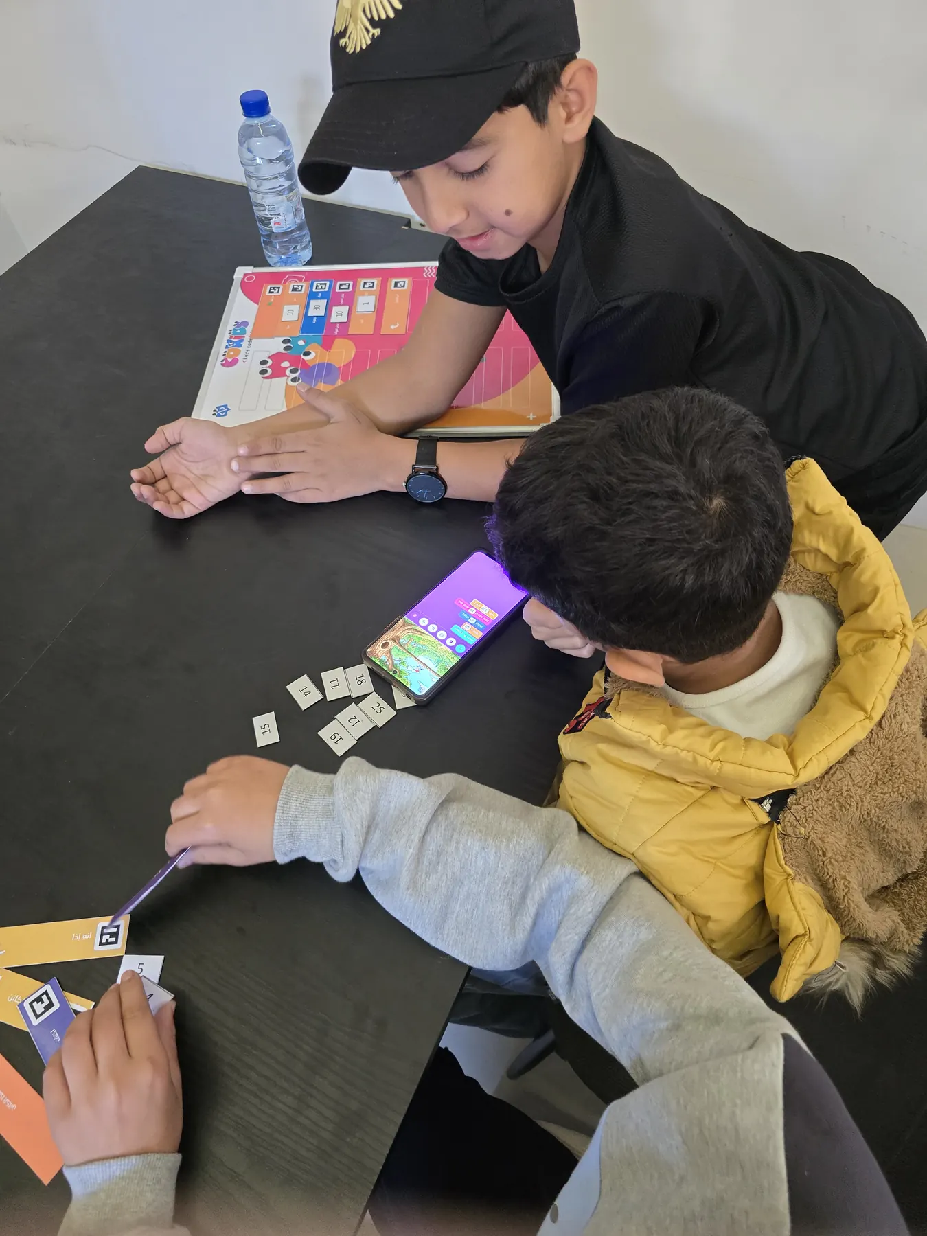 Children learning to code with the CoKids kit