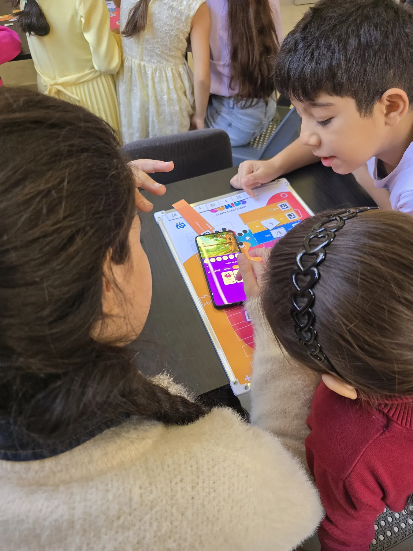 Children learning to code with the CoKids kit