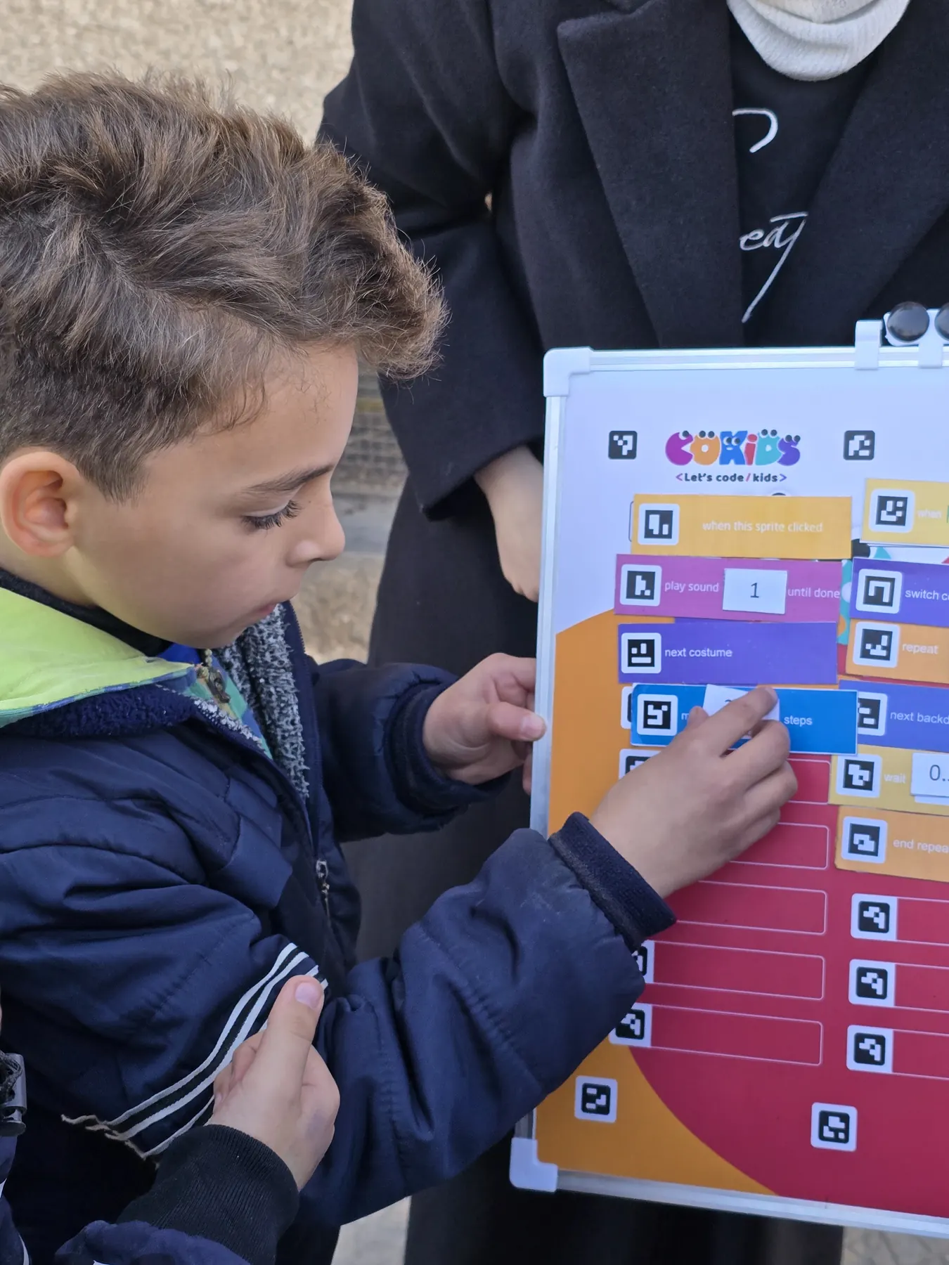 Children learning to code with the CoKids kit