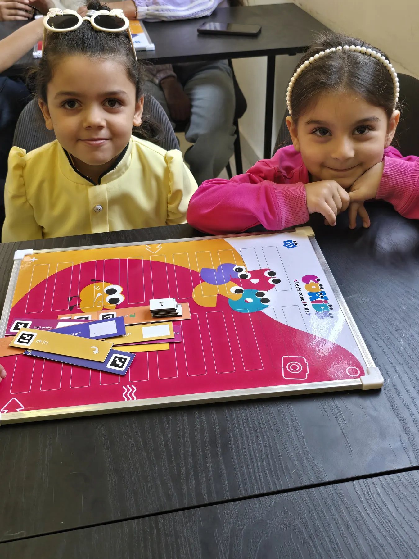 Children learning to code with the CoKids kit