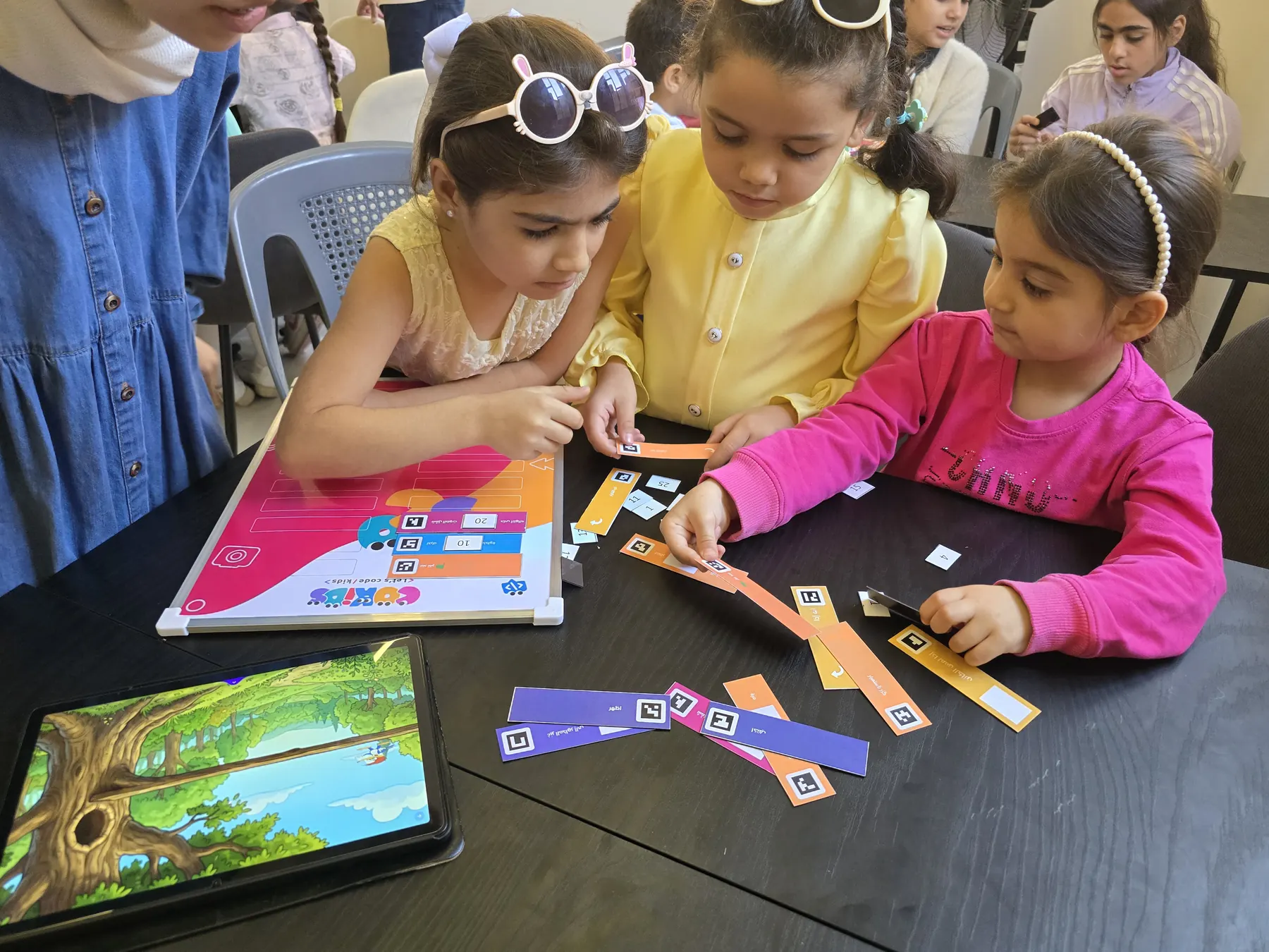 Children learning to code with the CoKids kit